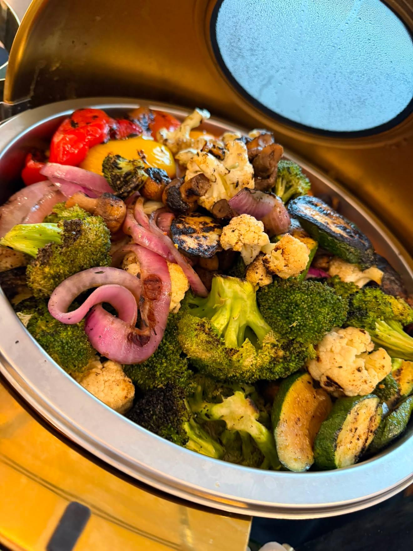 Chef Tyrone at the buffet — golden chafing setup
